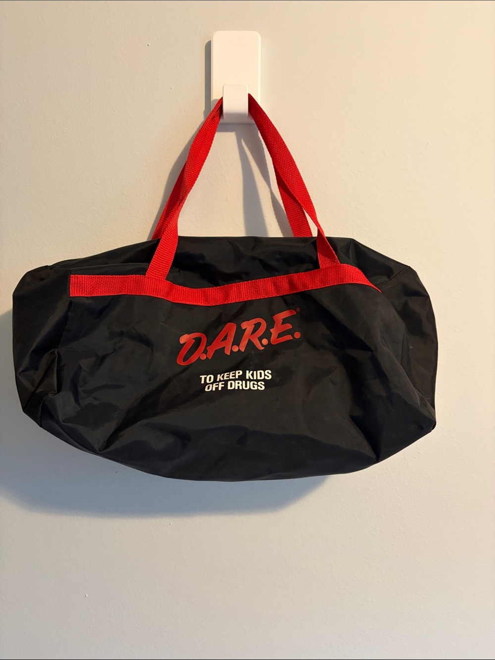 Vintage Black Duffel Bag with Red Handles and Logo